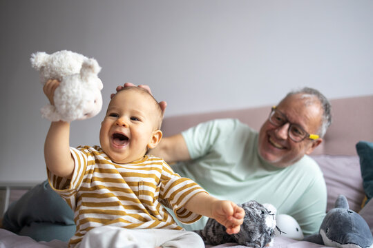 Grandfather and grandchild enjoy playful time together