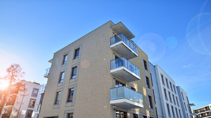 Modern apartment building in sunny day. Exterior, residential house facade. Residential area with modern, new and stylish living block of flats. 