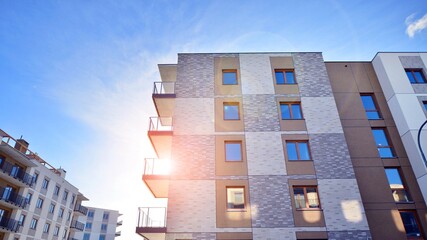 Modern apartment building in sunny day. Exterior, residential house facade. Residential area with modern, new and stylish living block of flats. 