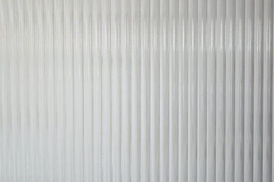 A Close up of corrugated glass texture with reflected,modern home decor,stylish home decor,Creative composition of living room,Wave glass vertical line pattern,Template.