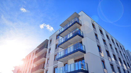 Modern apartment building in sunny day. Exterior, residential house facade. Residential area with modern, new and stylish living block of flats.  © Grand Warszawski
