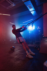 Intense TRX Workout Session in Neon Lit Gym