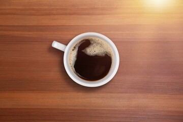 Tasty hot coffee with foam in cup