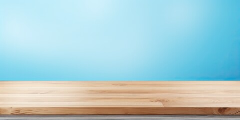 Display or montage your products on a light blue abstract background with a wood table top.