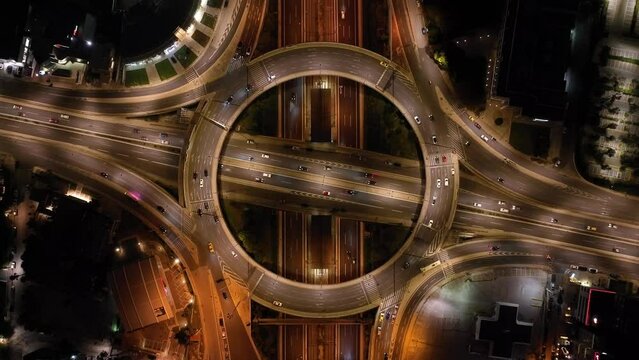 Aerial drone night cinematic video of illuminated urban elevated toll ring road junction and interchange overpass passing through Kifisias Avenue, Attica, Greece
