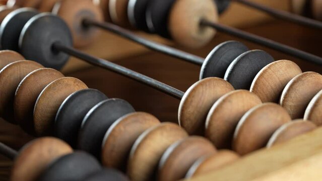 Vintage wooden abacus lying on the wooden table background, close up