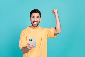 Photo of addicted guy shopaholic wearing fist up celebrate discount coupon in lottery using phone...