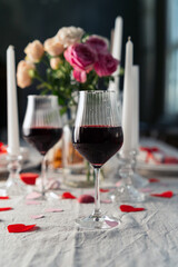 Glasses with red cocktails on festive table. Valentine day dinner settings