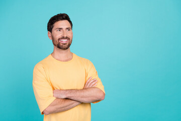 Fototapeta premium Photo of handsome brunet hair man wear yellow t shirt folded hands looking novelty plans for future isolated on cyan color background
