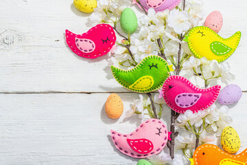 Beautiful Easter background with traditional decor. Flowers, decorative eggs, birds and rabbits