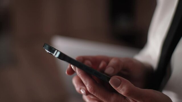 Close-up hands of unrecognizable female hands holding using smartphone. Closeup cropped shot of woman enjoy online chat, internet purchase, browse web, download new cool freeware application.