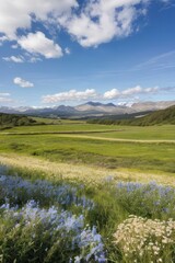 Obraz premium Beautiful Summer Countryside Landscape with Mountains, Blue Sky, Lake, and Lush Greenery