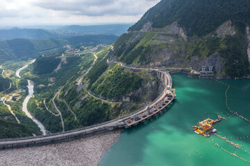 Inguri hydroelectric power plant in Georgia. Aerial view from drone of huge water dam. Hydropower energy station on Inguri River. - obrazy, fototapety, plakaty