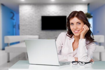 Young pretty woman student thinking at work