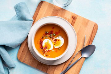 Butternut squash soup  with boiled egg, autumn or winter delicious healthy food