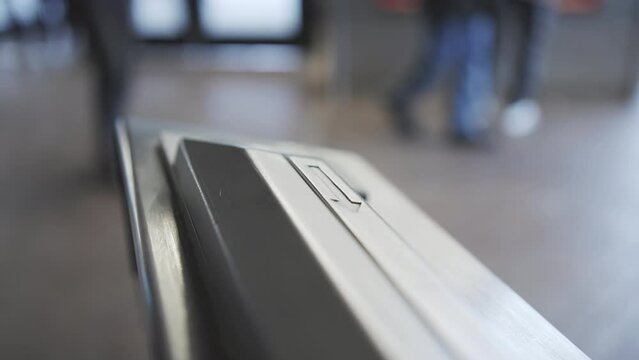 Hand pulling metro card through terminal in subway station 4k