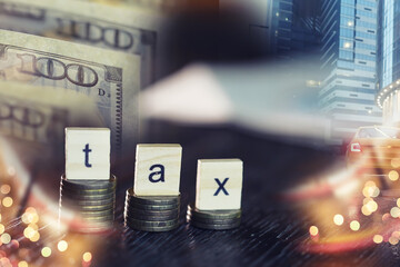 Tax wooden letter on wooden block.Pay tax .Income tax return. Double exposure city, dollar.