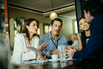Diverse business people talking in cafe or bar