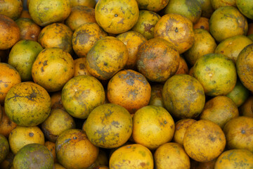 Stacks of orange fruits inside a traditional market in a local city