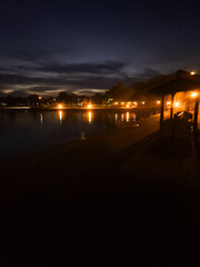 Fototapeta na wymiar Lakeside Luminescence: A Nighttime Spectacle