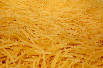 Close up of a pile of dry vermicelli pasta background. Pasta for soup