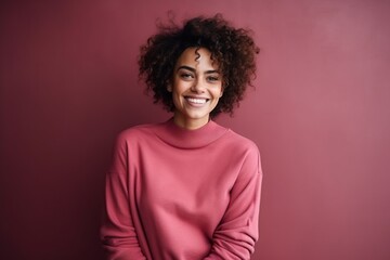 Obraz na płótnie Canvas Portrait of a beautiful african american woman in pink sweater