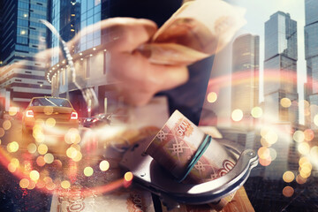 Double exposure of male hands locked in handcuffs city landscape background. Hands in handcuffs behind, holding five thousand rubles.