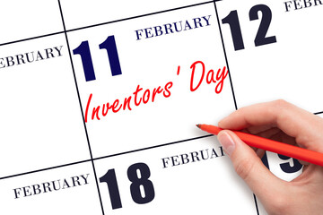 February 11. Hand writing text Inventors' Day on calendar date. Save the date.