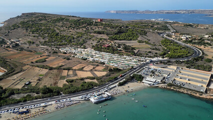 Aerial view of Red Tower in Mellieha ,Malta. Sandy beach with coastal road towards the Gozo ferry terminal.