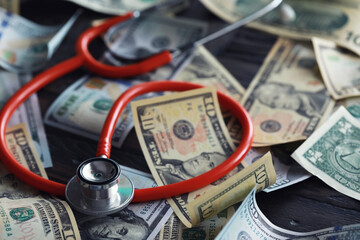 Financial analysis, auditing or business concept. Symbolic image of US Dollar banknotes with stethoscope.