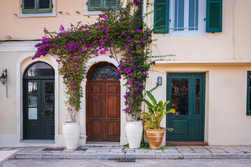 Vintage Mediterranean old town street with traditional old houses, beautiful doors and windows, with bougainvillea.