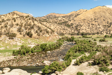 Mountains, stream  and blue sky in arid central California, USA 