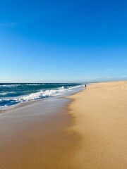 Fototapeta na wymiar Sand beach, sea coastline, pure blue sky, natural seascape background, no people