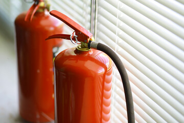 hand presses the trigger fire extinguisher available in fire emergencies conflagration damage...