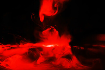 Red smoke over black studio background. Red steam on a black background. Copy space.