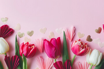 Stylish hearts and tulips on pink background flat lay. Happy Valentines day and happy mothers day....