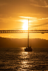 golden gate bridge at sunset with a boat 