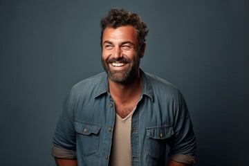 Portrait of a happy casual man smiling at the camera over grey background