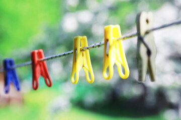 Dry clothes outside. Clothes on a rope. Clothespins on a clothesline in summer.