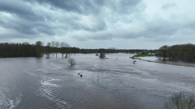 High water level in the river Vecht where the river Regge flows into the Vecht in the Vechtdal region near Ommen in Overijssel. The river is overflowing on the floodplains after heavy rainfalll upstre