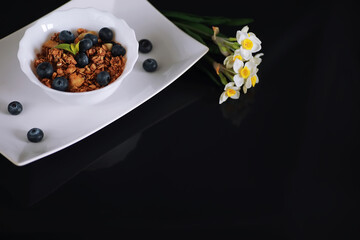 A healthy breakfast cereal with milk and fruit. Oat and corn flakes with chocolate and yogurt. The concept of healthy and vegetarian food.