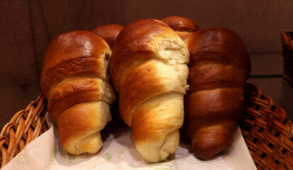 Testy Croissant for breakfast ,closeup photo of croissant on a busket ,brown and white bread