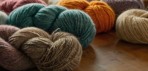  a group of skeins of yarn sitting on top of a wooden floor next to a pile of balls of yarn on top of a wooden floor next to each other skeins.