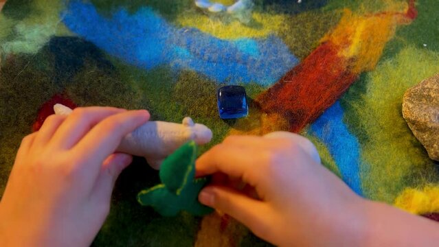 the hands of a child playing with natural Waldorf toys video