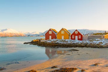 Rolgordijnen Traditional red and yellow wooden norwegian cabins with ground on the roof. Tromso, Norway © johnkruger1