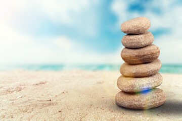 Fototapeta na wymiar Stone Natural pebble tower on the beach.