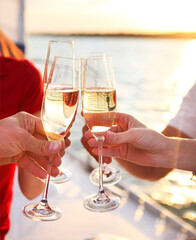 Happy friends with glasses of champagne on yacht. Vacation, travel, sea and friendship concept © Dasha Petrenko