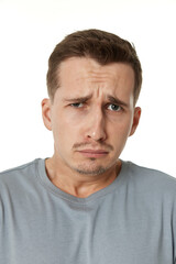 Obraz premium offended frustrated young man on white background. sadness