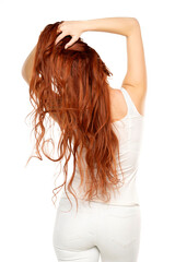 Fototapeta premium Back view of redhead woman with long ginger wavy hair on a white background