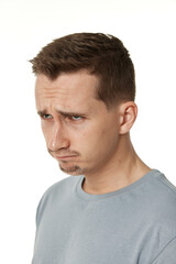 Fototapeta premium offended frustrated young man on white background. sadness